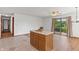 The kitchen island seamlessly transitions into a dining area with sliding glass doors at 370 Vinewood S Dr, Brownsburg, IN 46112