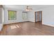 Bright living room featuring wood-look flooring, large windows, and a ceiling fan at 370 Vinewood S Dr, Brownsburg, IN 46112