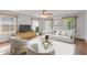 Bright living room with large windows, stylish furniture, and hardwood floors, creating a comfortable ambiance at 370 Vinewood S Dr, Brownsburg, IN 46112