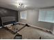Primary bedroom with carpet, large windows, modern ceiling light, and accent wall at 3836 N Wittfield St, Indianapolis, IN 46235