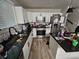 Modern kitchen with white cabinets, stainless steel appliances, and granite countertops at 3836 N Wittfield St, Indianapolis, IN 46235