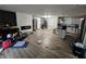 Open concept living room with hardwood floors, a fireplace, and kitchen access at 3836 N Wittfield St, Indianapolis, IN 46235