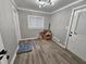 Cozy room with beadboard walls, light hardwood floors, and a large window at 3836 N Wittfield St, Indianapolis, IN 46235