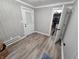 Cozy room with beadboard walls, light hardwood floors, and access to an exterior door at 3836 N Wittfield St, Indianapolis, IN 46235