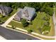Aerial view of home featuring a manicured lawn, mature trees, and a well-maintained exterior at 3853 Abney Highland Dr, Zionsville, IN 46077
