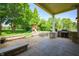 Covered back porch featuring a built-in grill, stone accents, a patio, and a spacious backyard at 3853 Abney Highland Dr, Zionsville, IN 46077