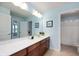 Bright bathroom with long vanity, well-lit mirror, and a separate toilet/shower room, and light blue walls at 3853 Abney Highland Dr, Zionsville, IN 46077
