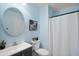 Bathroom with blue walls, round mirror, and white shower curtain at 3853 Abney Highland Dr, Zionsville, IN 46077