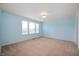 Cozy blue bedroom with large windows, offering a bright and airy atmosphere, and plush carpet at 3853 Abney Highland Dr, Zionsville, IN 46077