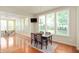 Bright dining area with large windows, modern table, and seating with views to the living area at 3853 Abney Highland Dr, Zionsville, IN 46077