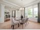 Bright dining room with a glass table, elegant chairs, and large windows at 3853 Abney Highland Dr, Zionsville, IN 46077