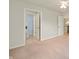 Open hallway leading to bathroom and second story with a carpeted floor and ceiling fan at 3853 Abney Highland Dr, Zionsville, IN 46077