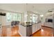 Bright kitchen island with seating, stainless steel appliances, and adjacent dining area at 3853 Abney Highland Dr, Zionsville, IN 46077