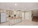 Kitchen boasts white cabinets, stainless appliances, and granite countertops on island at 3853 Abney Highland Dr, Zionsville, IN 46077