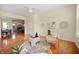 Inviting living room with hardwood floors, decorative wall art, and comfortable seating arrangement at 3853 Abney Highland Dr, Zionsville, IN 46077