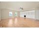 Bright living room with hardwood floors, two windows, and built-in shelving at 3853 Abney Highland Dr, Zionsville, IN 46077