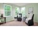 Well-lit sitting area with comfortable chairs offers a relaxing space within the large main bedroom at 3853 Abney Highland Dr, Zionsville, IN 46077