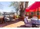 Relaxing back deck area with a swing, a table and chairs, and a large tree in the middle at 40 S Restin Rd, Greenwood, IN 46142