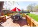 Wide-angle shot of the backyard deck featuring a table, chairs, and a large backyard lawn at 40 S Restin Rd, Greenwood, IN 46142