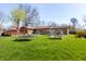 Expansive backyard featuring a trampoline, garden, playset, and deck at 40 S Restin Rd, Greenwood, IN 46142