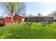 Large backyard with deck, swingset, and plenty of grass for activities at 40 S Restin Rd, Greenwood, IN 46142