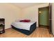 Bedroom with hardwood floors, open door, and neutral wall color at 40 S Restin Rd, Greenwood, IN 46142