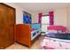 Well-lit bedroom featuring two beds with bright curtains and flooring at 40 S Restin Rd, Greenwood, IN 46142