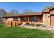 Charming single-story home with inviting orange front door, porch, landscaped garden, and access ramp at 40 S Restin Rd, Greenwood, IN 46142