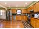 Well-lit kitchen with stainless appliances, tiled backsplash, and wood floors at 40 S Restin Rd, Greenwood, IN 46142