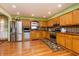Spacious kitchen boasts stainless steel appliances, wood floors, and updated lighting at 40 S Restin Rd, Greenwood, IN 46142