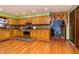 Well-lit kitchen features wood cabinets, stainless steel appliances, and mosaic tile backsplash at 40 S Restin Rd, Greenwood, IN 46142