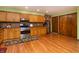 Updated kitchen boasts wood floors, stainless steel oven, and wood cabinets at 40 S Restin Rd, Greenwood, IN 46142