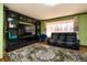 Cozy living room featuring a black leather couch, unique rug, and built in shelving at 40 S Restin Rd, Greenwood, IN 46142
