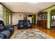 Cozy living room with modern furniture, hardwood floors, a patterned rug, and view of front entrance at 40 S Restin Rd, Greenwood, IN 46142