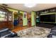 Well maintained living room showing hardwood floors, a patterned rug, and a seamless flow to kitchen at 40 S Restin Rd, Greenwood, IN 46142