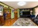 Spacious living room boasts wood floors, tv, and view into the kitchen at 40 S Restin Rd, Greenwood, IN 46142