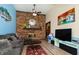 Living room with a brick fireplace, television, and comfortable seating area at 40 S Restin Rd, Greenwood, IN 46142