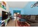 Comfortable living room with blue walls, brown sofa, and views to other rooms at 40 S Restin Rd, Greenwood, IN 46142