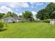 Expansive backyard featuring lush green grass, mature trees, and a charming gazebo creating a serene retreat at 402 W Clinton St, Danville, IN 46122