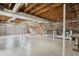 Open basement showcasing brick walls, exposed wood beams, utility infrastructure and ample space for storage at 402 W Clinton St, Danville, IN 46122