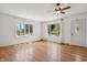 Bright living room featuring hardwood floors, a ceiling fan, and multiple windows at 402 W Clinton St, Danville, IN 46122