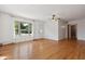 Bright living room featuring hardwood floors, a ceiling fan, and a large window at 402 W Clinton St, Danville, IN 46122