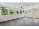 Bright sunroom with multiple windows, white walls, and a ceiling fan at 402 W Clinton St, Danville, IN 46122