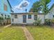 Back exterior view of a home featuring a green lawn and a pathway at 405 Harlan St, Indianapolis, IN 46201