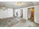The basement features a stairwell, concrete flooring, and a door leading to the outside at 405 Harlan St, Indianapolis, IN 46201