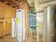 Water heater and HVAC system in unfinished basement with concrete walls and ceiling at 405 Harlan St, Indianapolis, IN 46201
