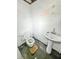 The bathroom includes a toilet and sink in the basement. Some drawings on the walls at 405 Harlan St, Indianapolis, IN 46201