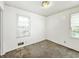 Bedroom featuring neutral walls, carpeting and two windows that provides natural light at 405 Harlan St, Indianapolis, IN 46201