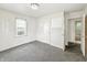 This bedroom features neutral walls, carpeting, and a door leading to an adjacent space at 405 Harlan St, Indianapolis, IN 46201