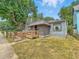 Charming home featuring accessible wooden ramp leading to lattice-covered porch at 405 Harlan St, Indianapolis, IN 46201